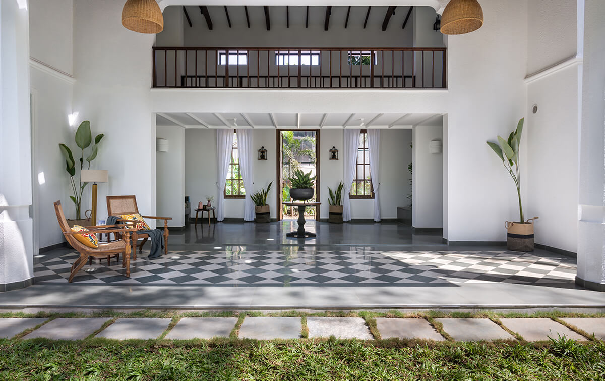 Open terrazzo tiled corridor at a 4bhk villa in Assagao